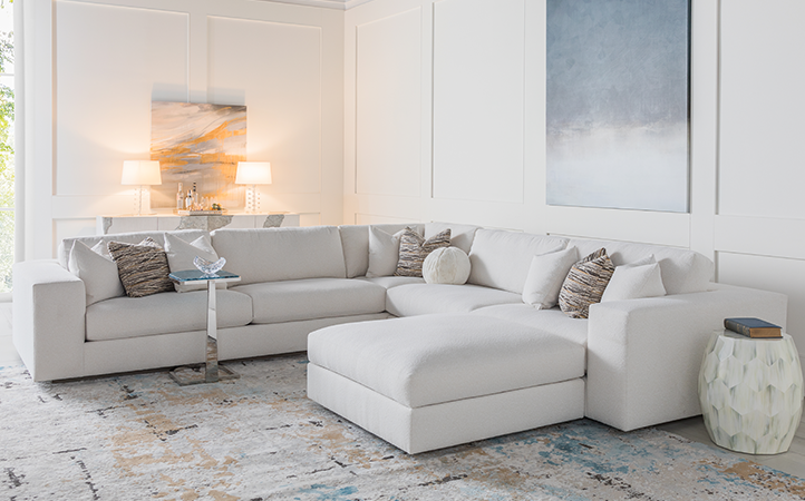 Artistica Upholstery scene featuring a sectional, console, and two accent tables.