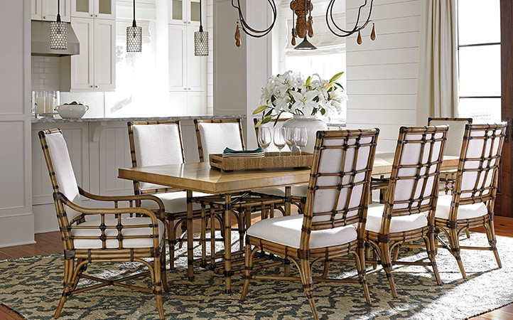 Twin Palms dining room features a dining table with eight rattan dining chairs.